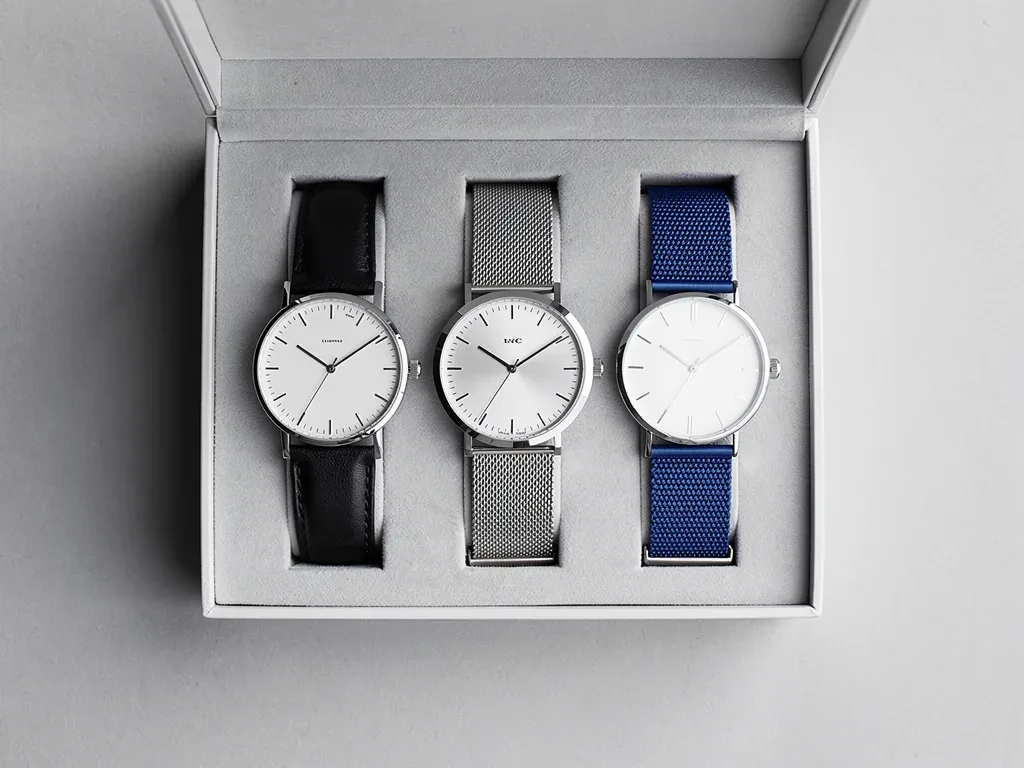 Three minimalist watches in a watch box, diverse styles