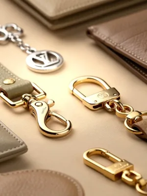 Collection of luxury designer bag accessories shimmering on a velvet background