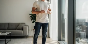 Man wearing a stylish core casual wardrobe with t-shirt, jeans, and sneakers