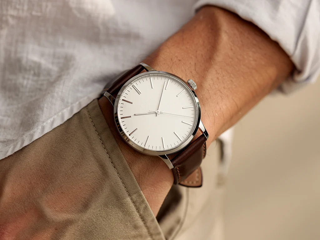 Minimalist watch on wrist, stainless steel, leather strap